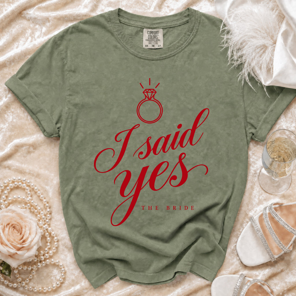 Green t-shirt with red "I said yes THE BRIDE" text and diamond ring graphic.