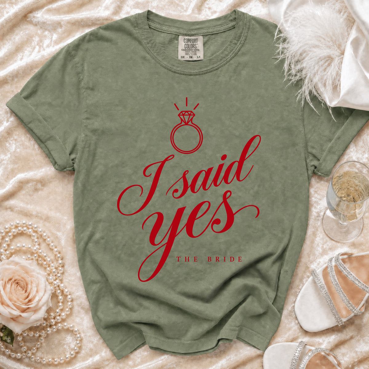 Green t-shirt with red "I said yes THE BRIDE" text and diamond ring graphic.