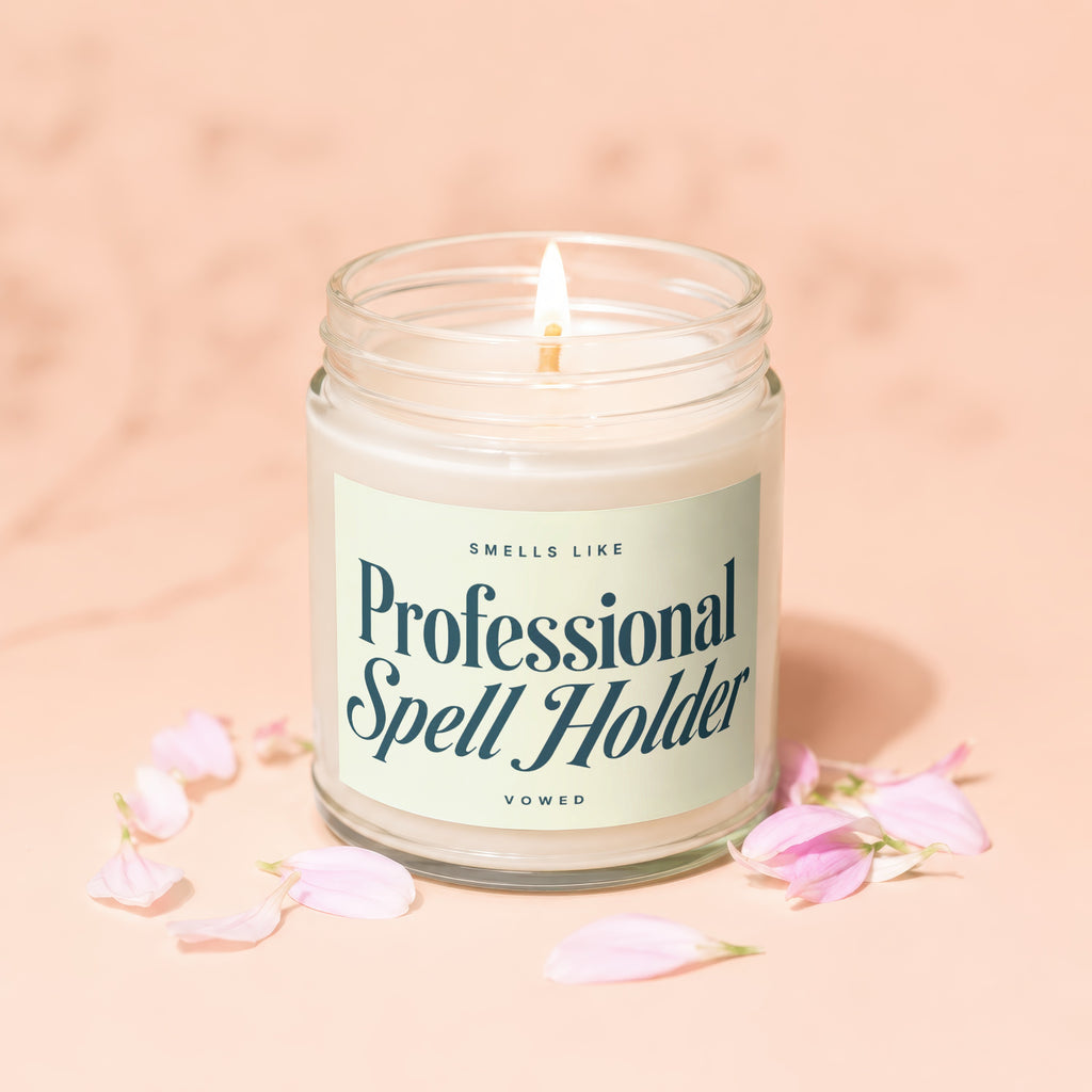 Craft candle with label reading "Smells Like Professional Spell Holder, Vowed".