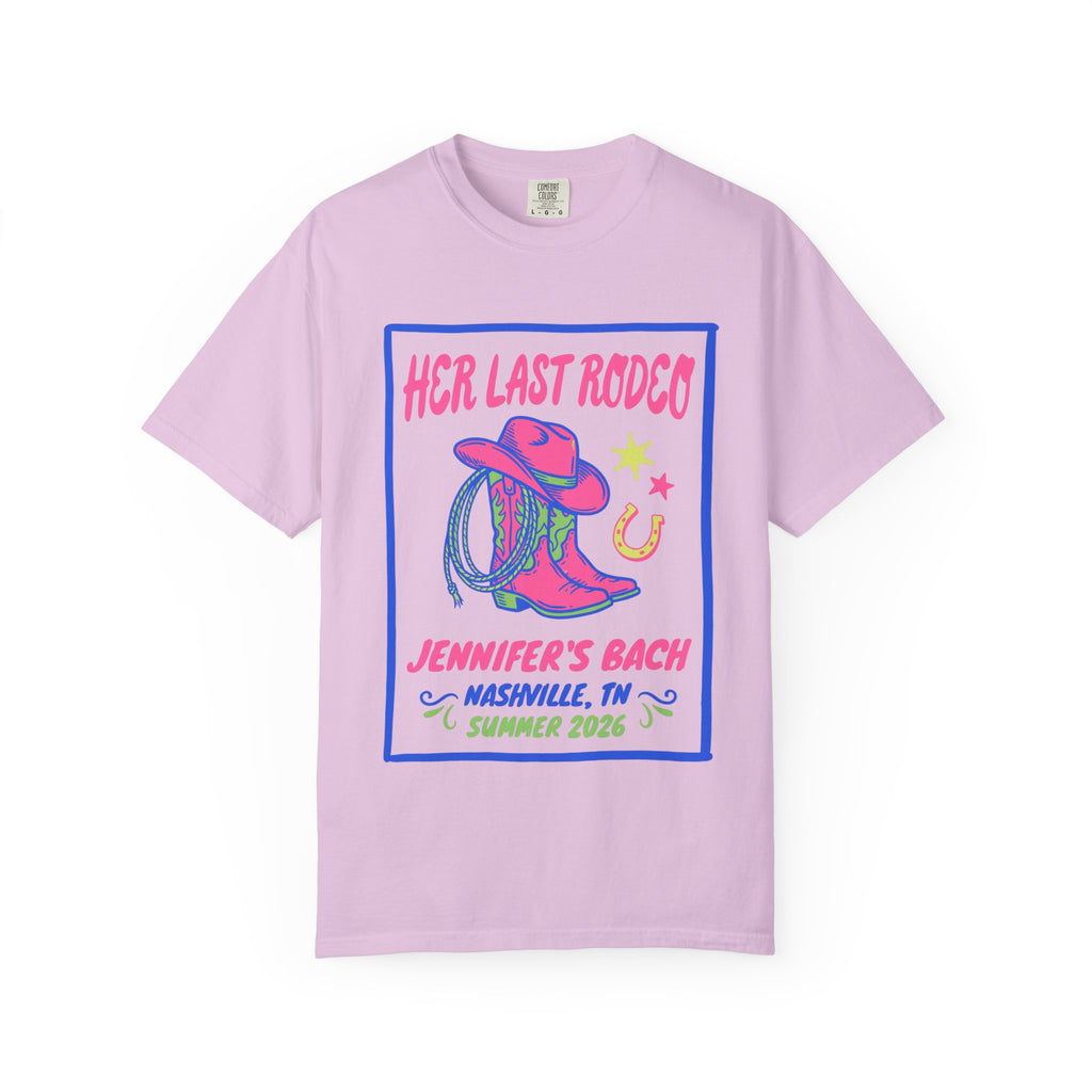 Pink t-shirt with "Her Last Rodeo" text, cowboy boots, and horseshoe graphic.