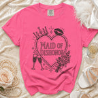 Pink t-shirt with "Maid of Dishonor" text, crown, lipstick, and champagne glasses graphic.