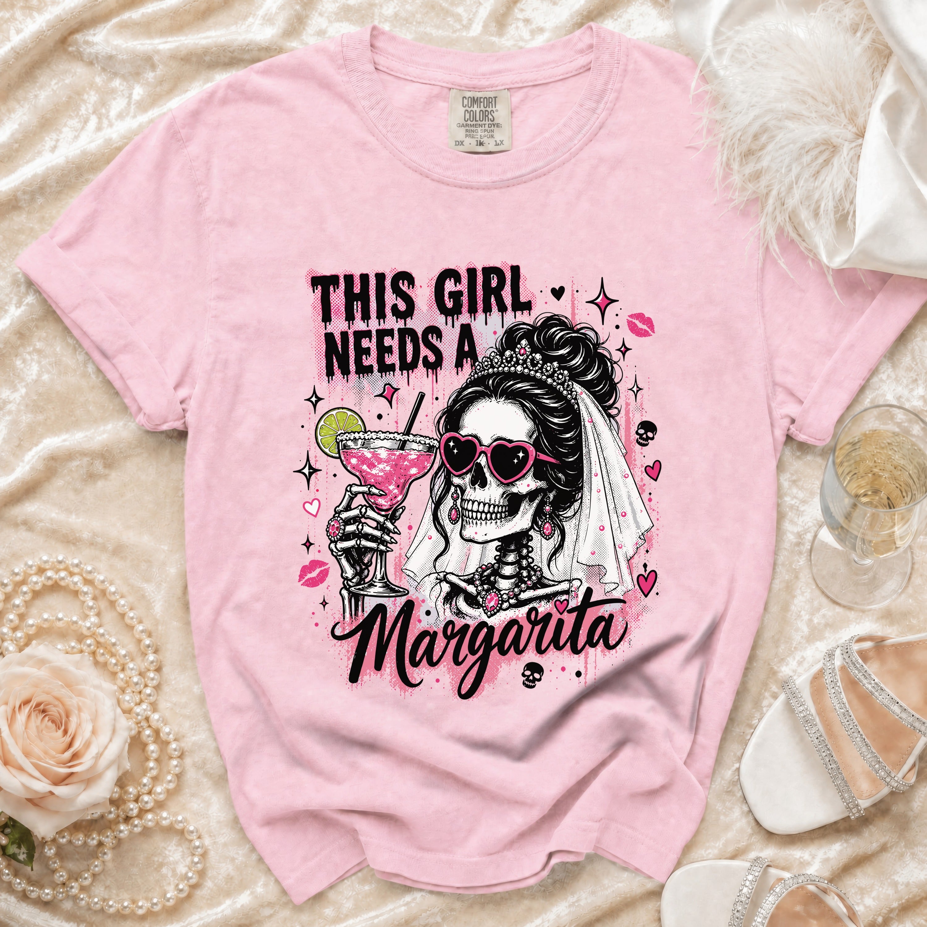 Pink t-shirt with graphic that reads "This girl needs a margarita."