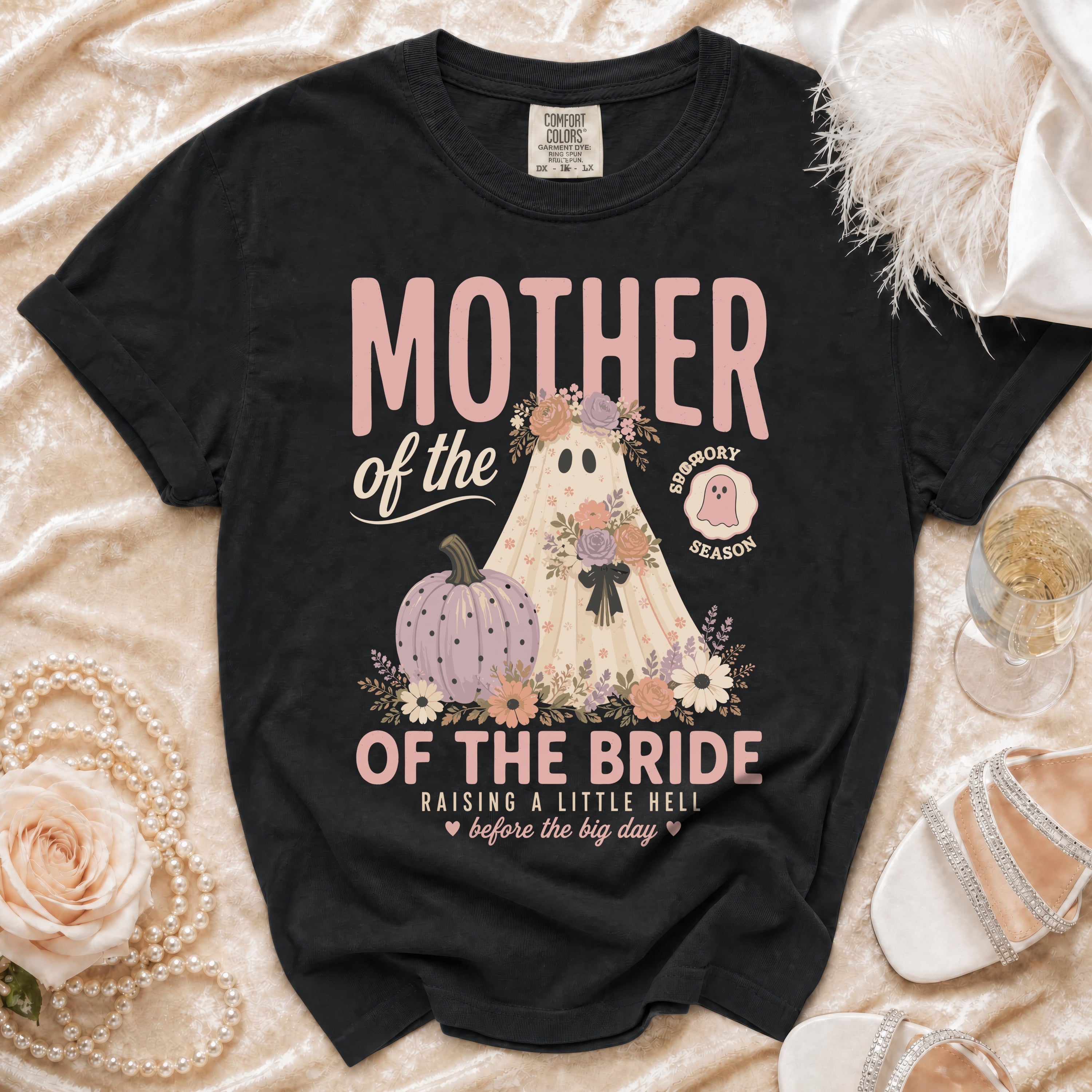 Black t-shirt with "Mother of the Bride" ghost, pumpkin, and floral graphic.