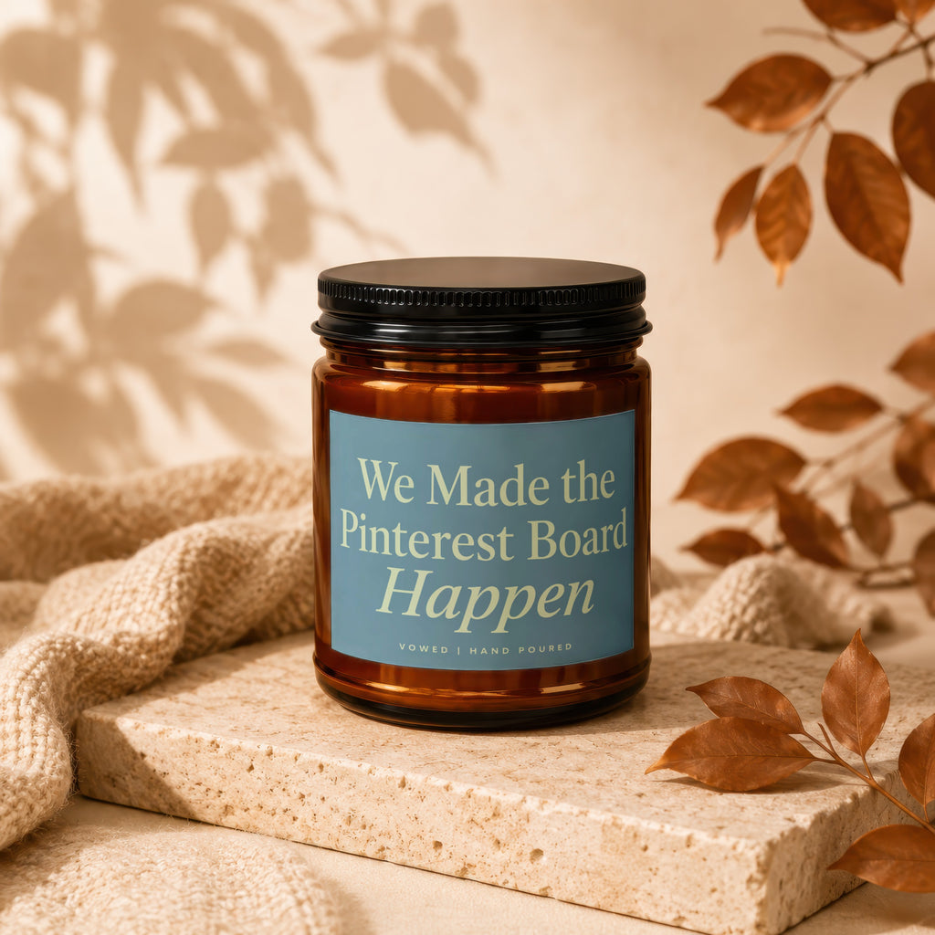 Amber jar candle with blue label reading "We Made the Pinterest Board Happen".