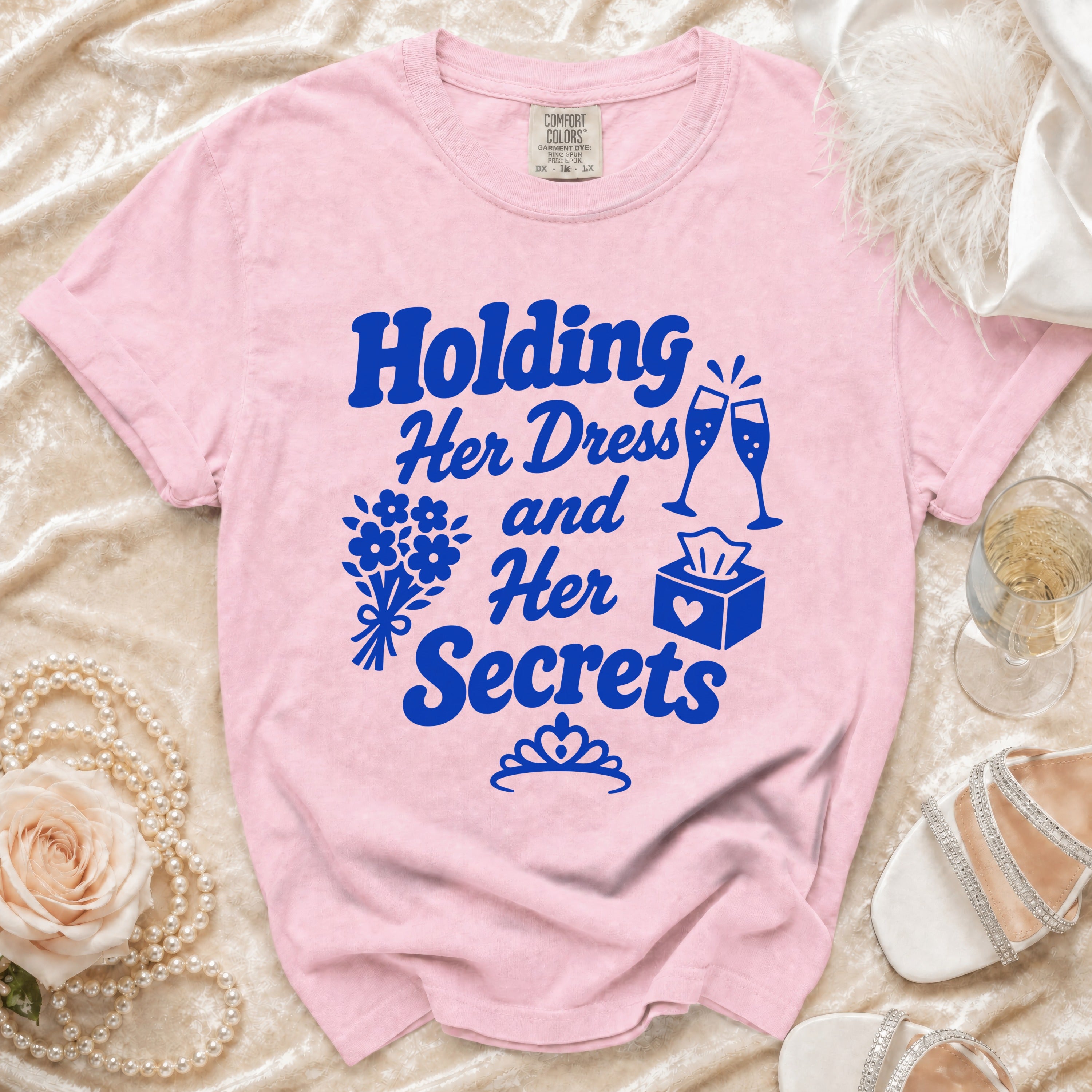 Pink t-shirt with "Holding Her Dress and Her Secrets" text and bridal graphics.