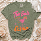 Green t-shirt with "This Bride Needs a Cosmo" text and martini graphic.