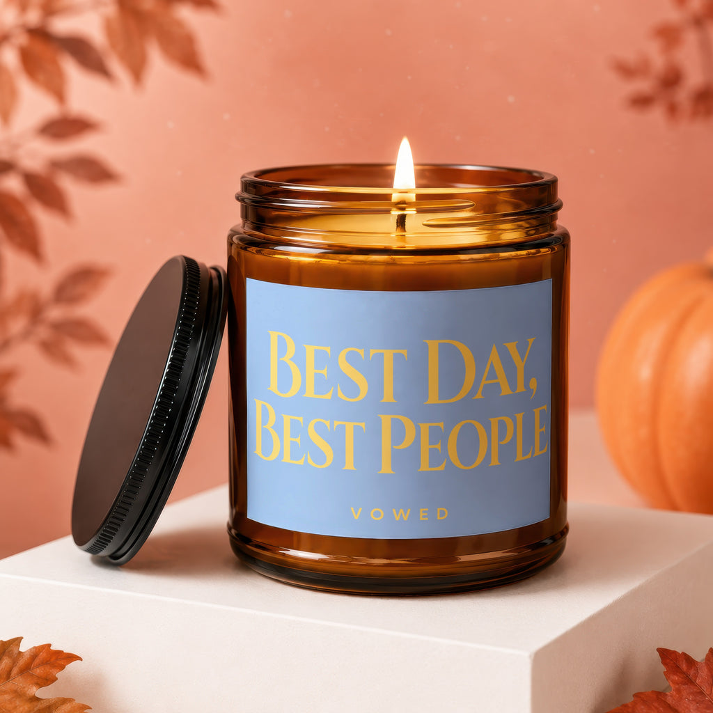 Amber jar candle with blue label reading "BEST DAY, BEST PEOPLE VOWED".