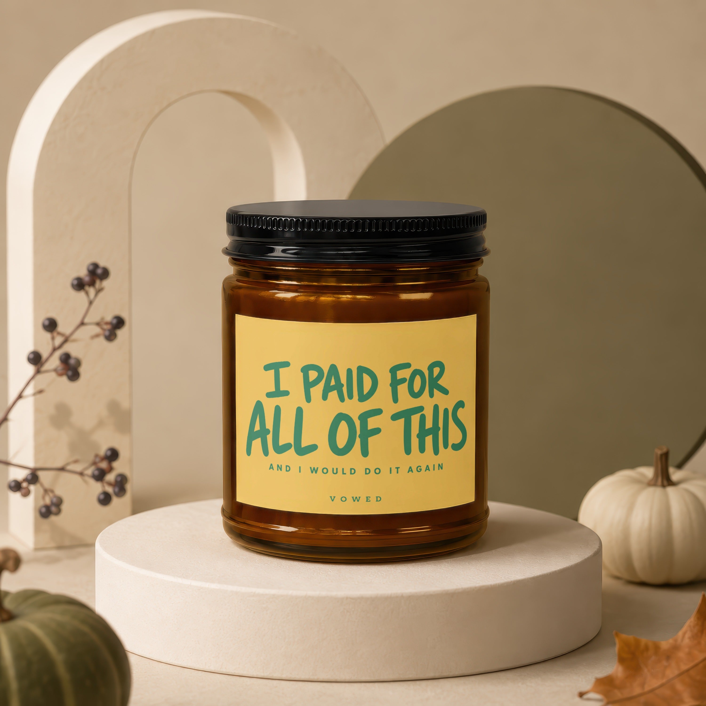 Brown candle with black lid and yellow label reading "I PAID FOR ALL OF THIS AND I WOULD DO IT AGAIN".