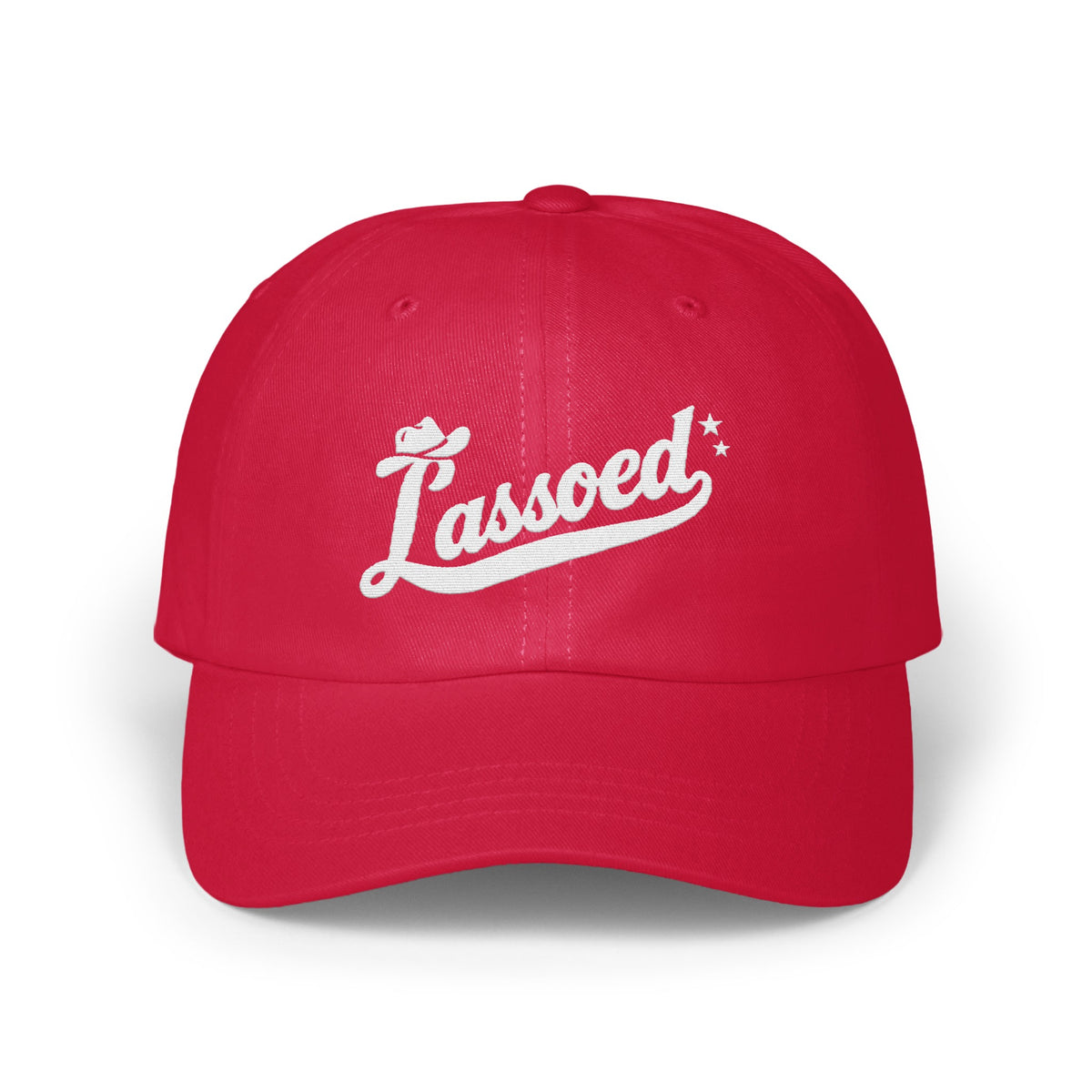 A bright red baseball cap embroidered with the white script word Lassoed across the front panel.