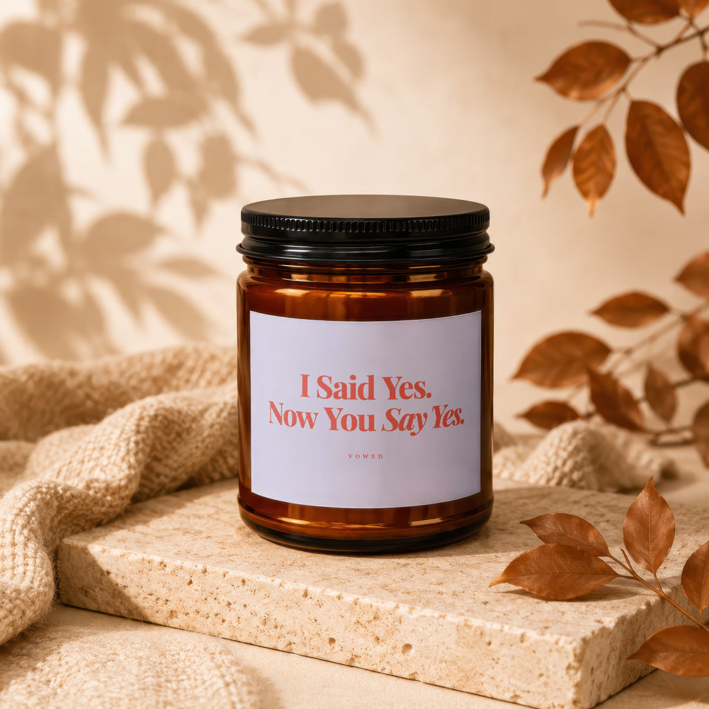 Amber candle in jar with black lid, label reads "I Said Yes. Now You Say Yes."