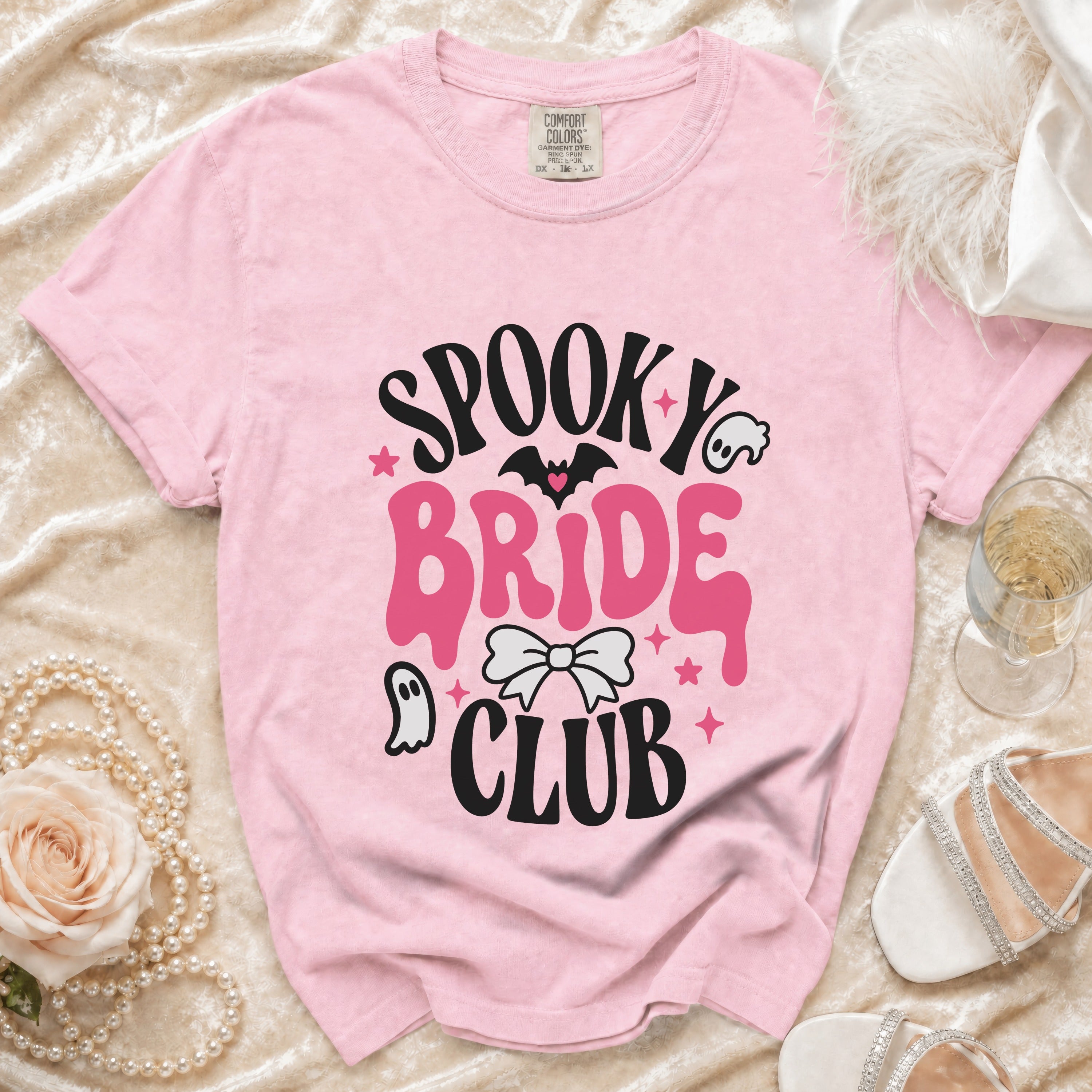 Pink t-shirt with "Spooky Bride Club" graphic featuring a ghost and bat.