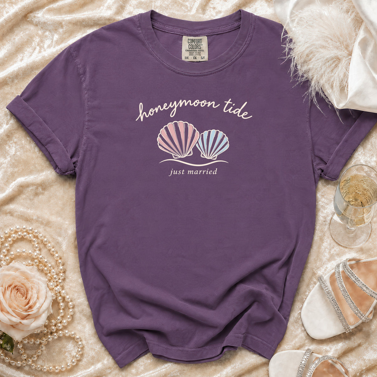 Purple t-shirt with "honeymoon tide just married" text and two shell graphics.