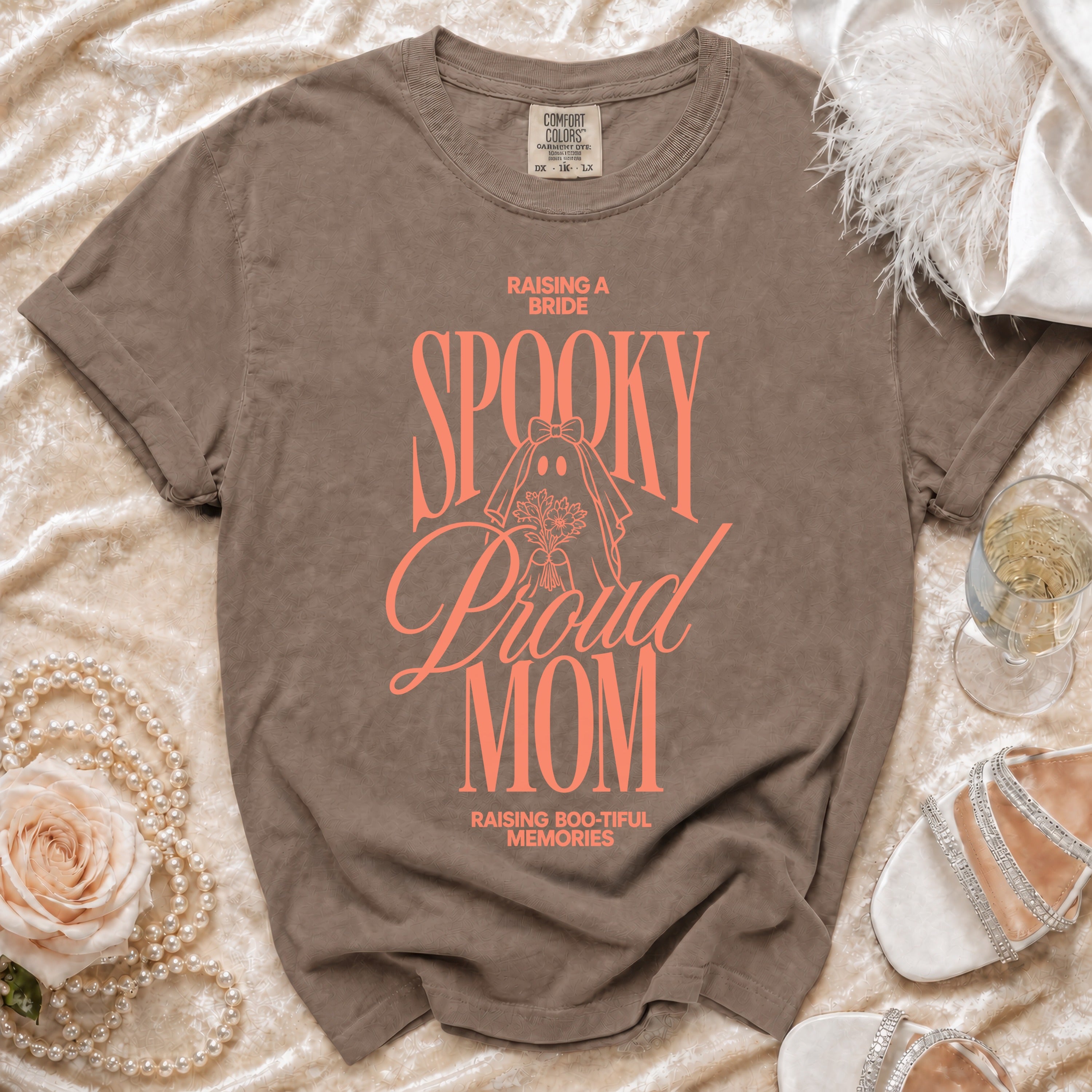 Comfort Colors t-shirt with "Raising a Bride, Spooky, Proud Mom, Raising Boo-tiful Memories" text.