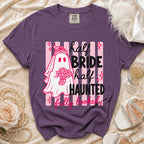 Purple t-shirt with ghost bride graphic and text "half bride half haunted fully booked".