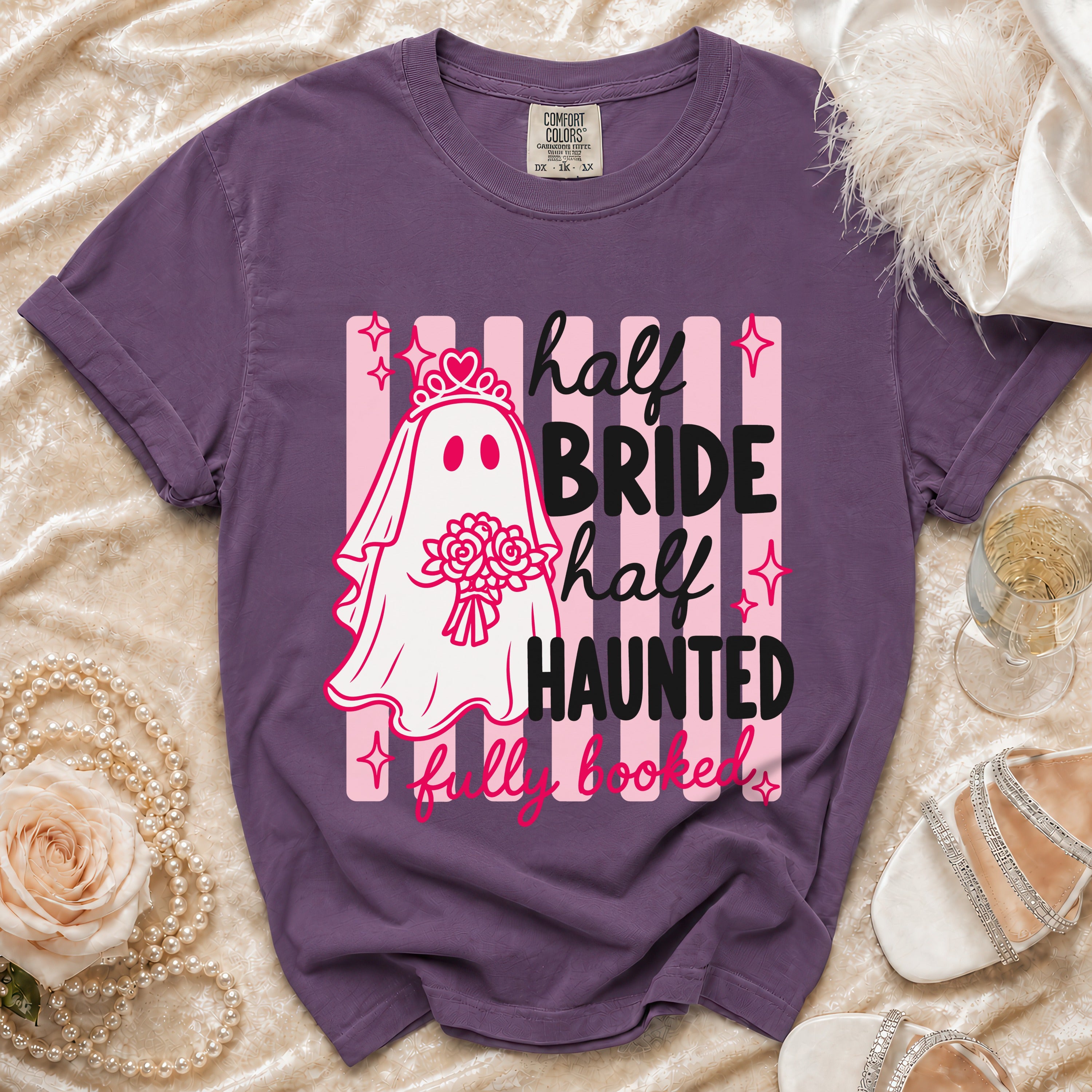 Purple t-shirt with ghost bride graphic and text "half bride half haunted fully booked".