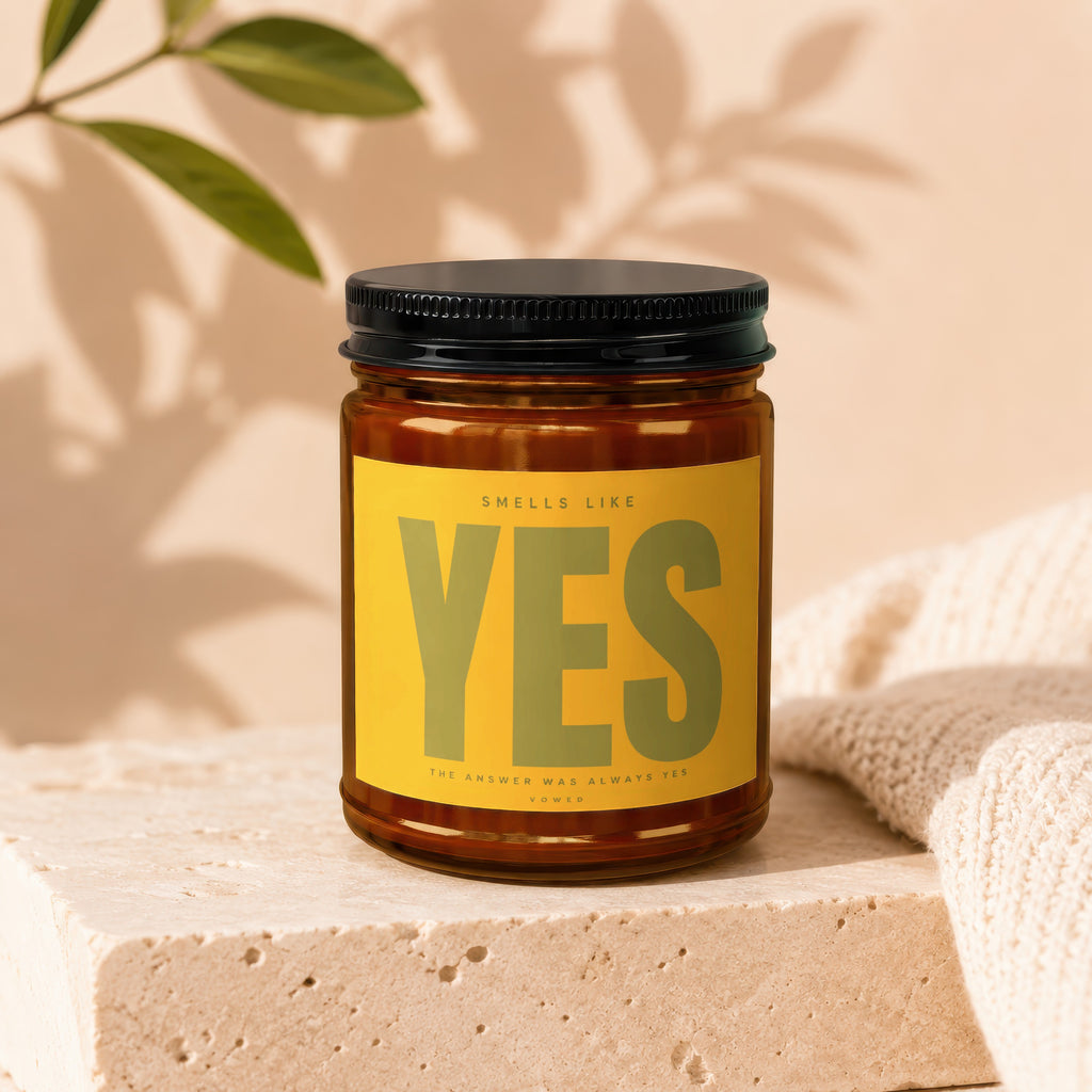 Amber jar candle with yellow label reading "Smells Like YES".