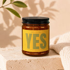 Amber jar candle with yellow label reading "Smells Like YES".