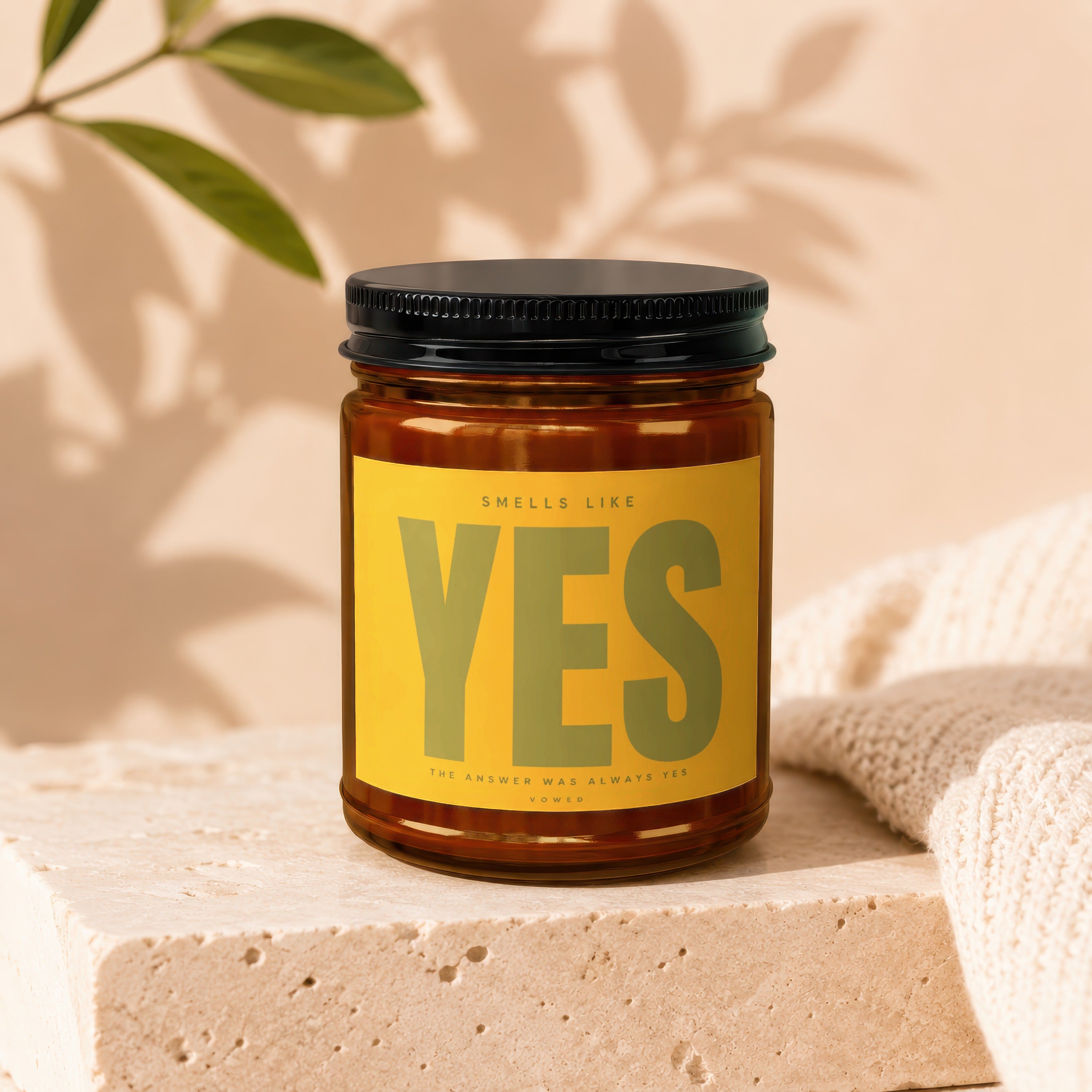 Amber jar candle with yellow label reading "Smells Like YES".