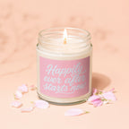 Candle with pink label that reads "Happily ever after starts now"