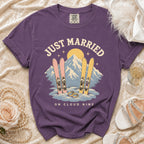 Purple t-shirt with "Just Married On Cloud Nine" text and ski graphic.