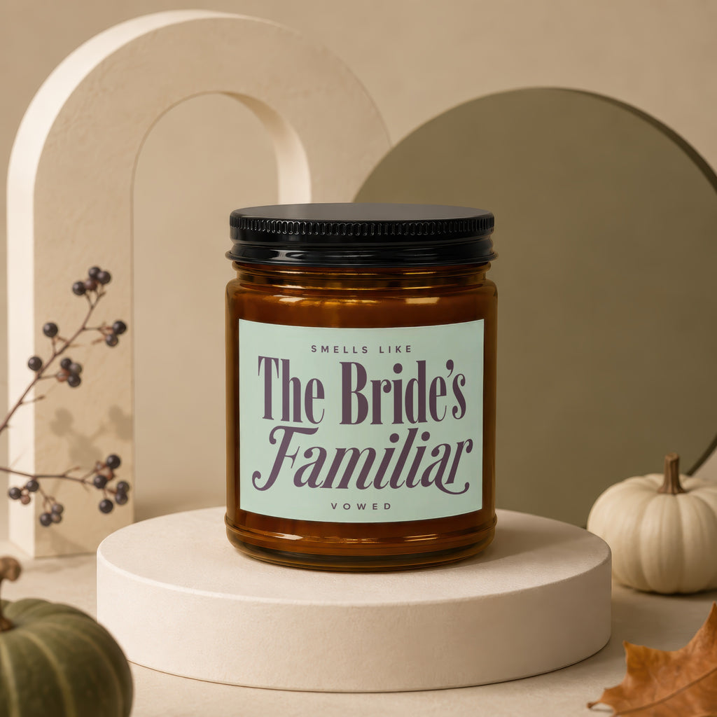 Amber jar candle with "The Bride's Familiar" and "vowed" text on a pale green label.