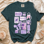 Dark teal t-shirt with "Honeymooning" graphics including postcards, playing cards, champagne, and pearls.