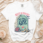 White t-shirt with "Rest in Pieces Here Lies My Single Life She Had a Good Run" graphic.