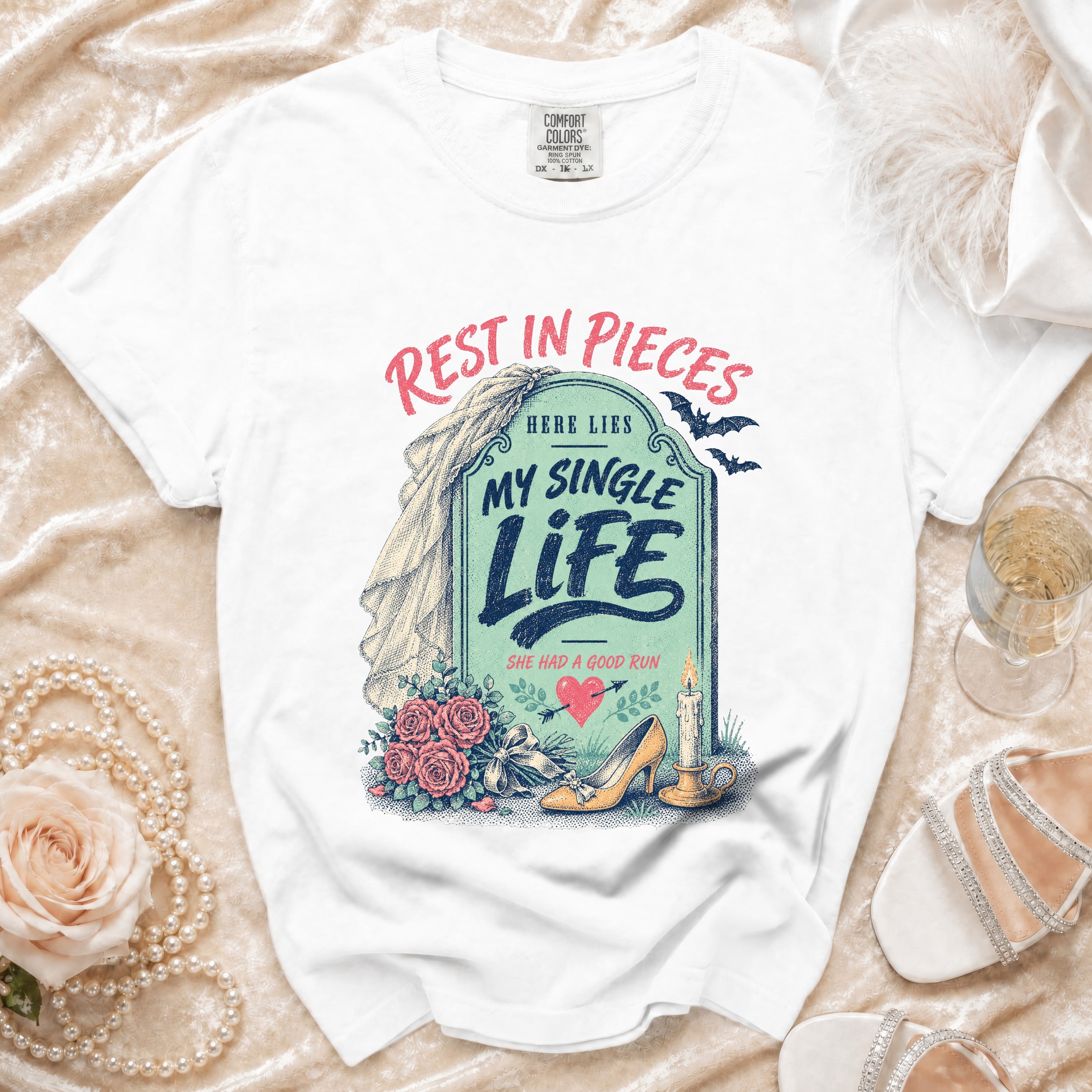 White t-shirt with "Rest in Pieces Here Lies My Single Life She Had a Good Run" graphic.