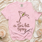 Pink Comfort Colors t-shirt with martini graphic and text "a tini bit tipsy".