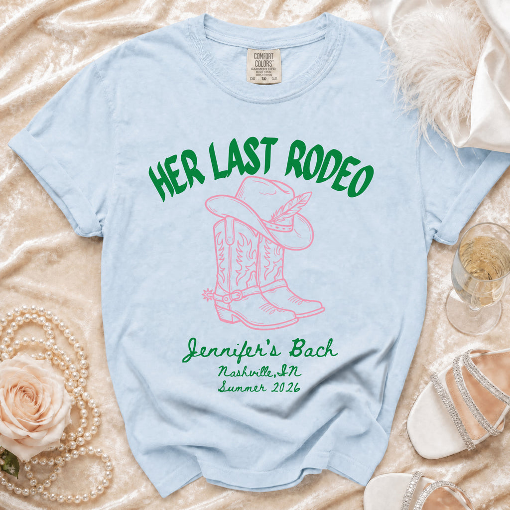 Light blue t-shirt with "Her Last Rodeo" and cowboy boot graphic.
