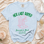 Light blue t-shirt with "Her Last Rodeo" and cowboy boot graphic.