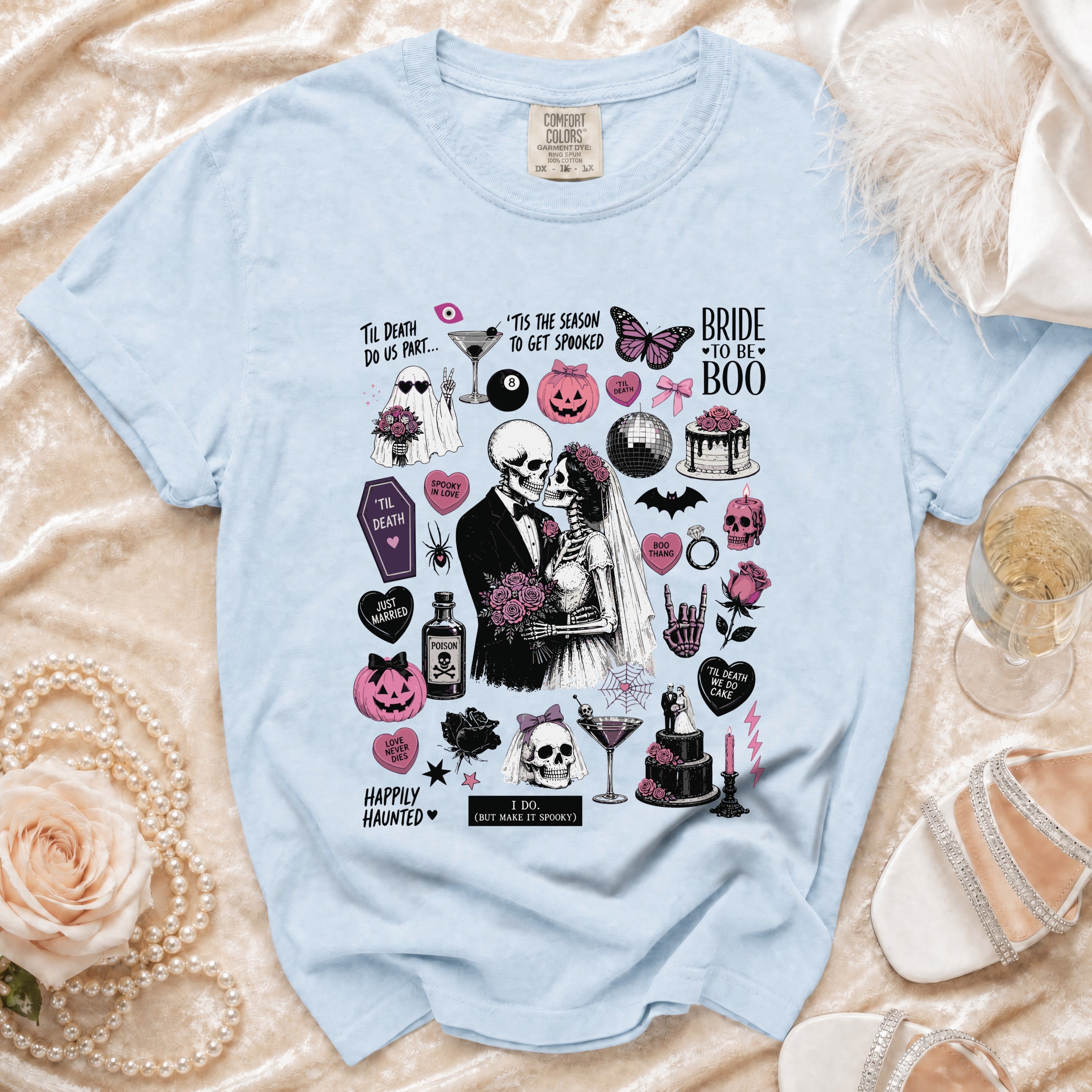 Light blue t-shirt with skeleton bride and groom and Halloween-themed graphics.