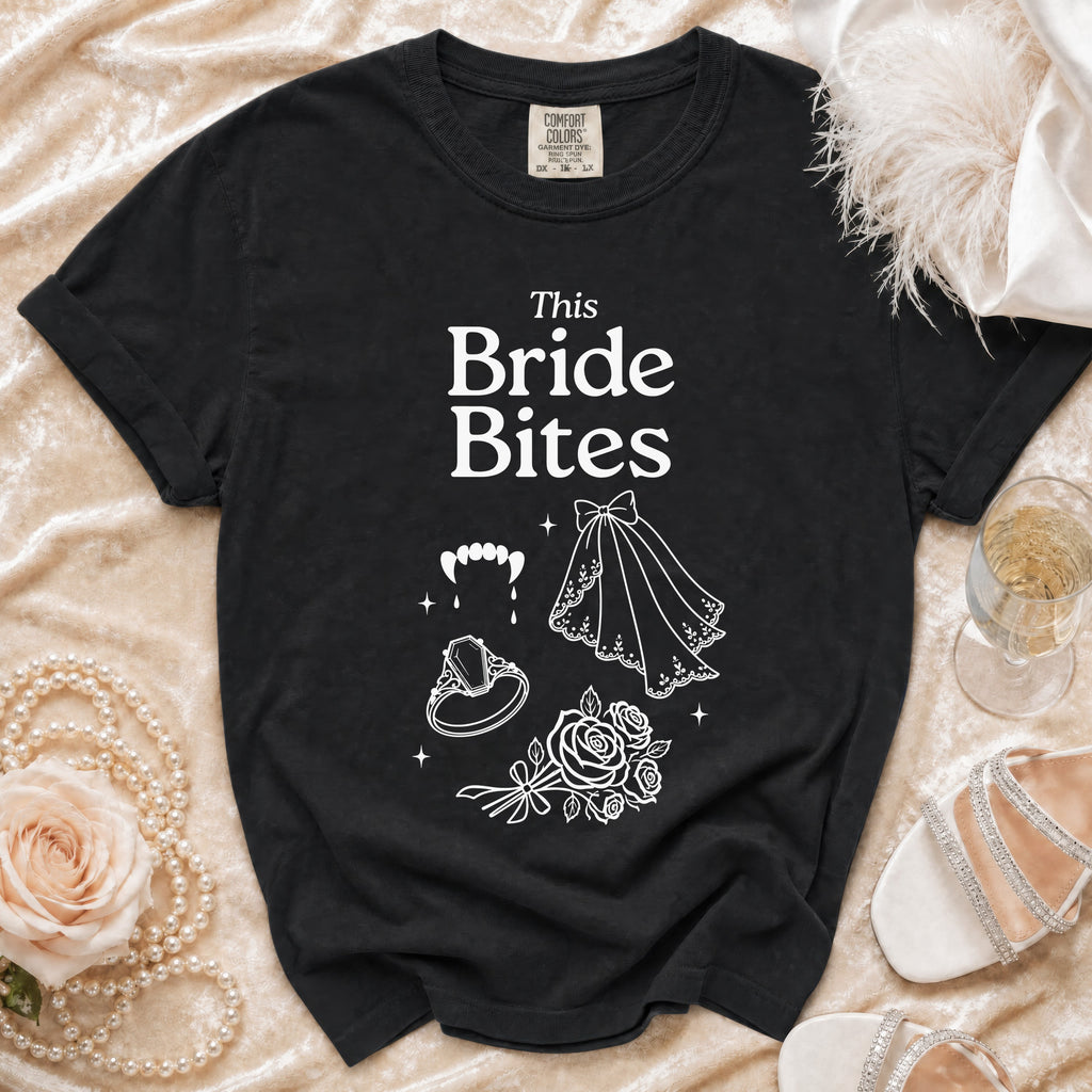 Black t-shirt with "This Bride Bites" text and vampire teeth graphic.