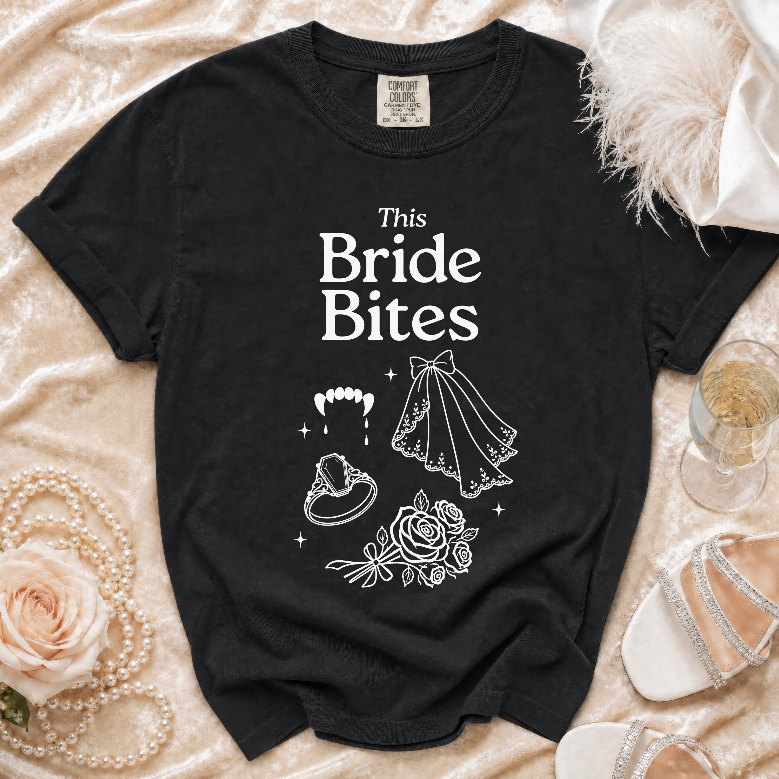 Black t-shirt with "This Bride Bites" text and vampire teeth graphic.