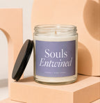 Glass candle with "Souls Entwined" label and black lid.