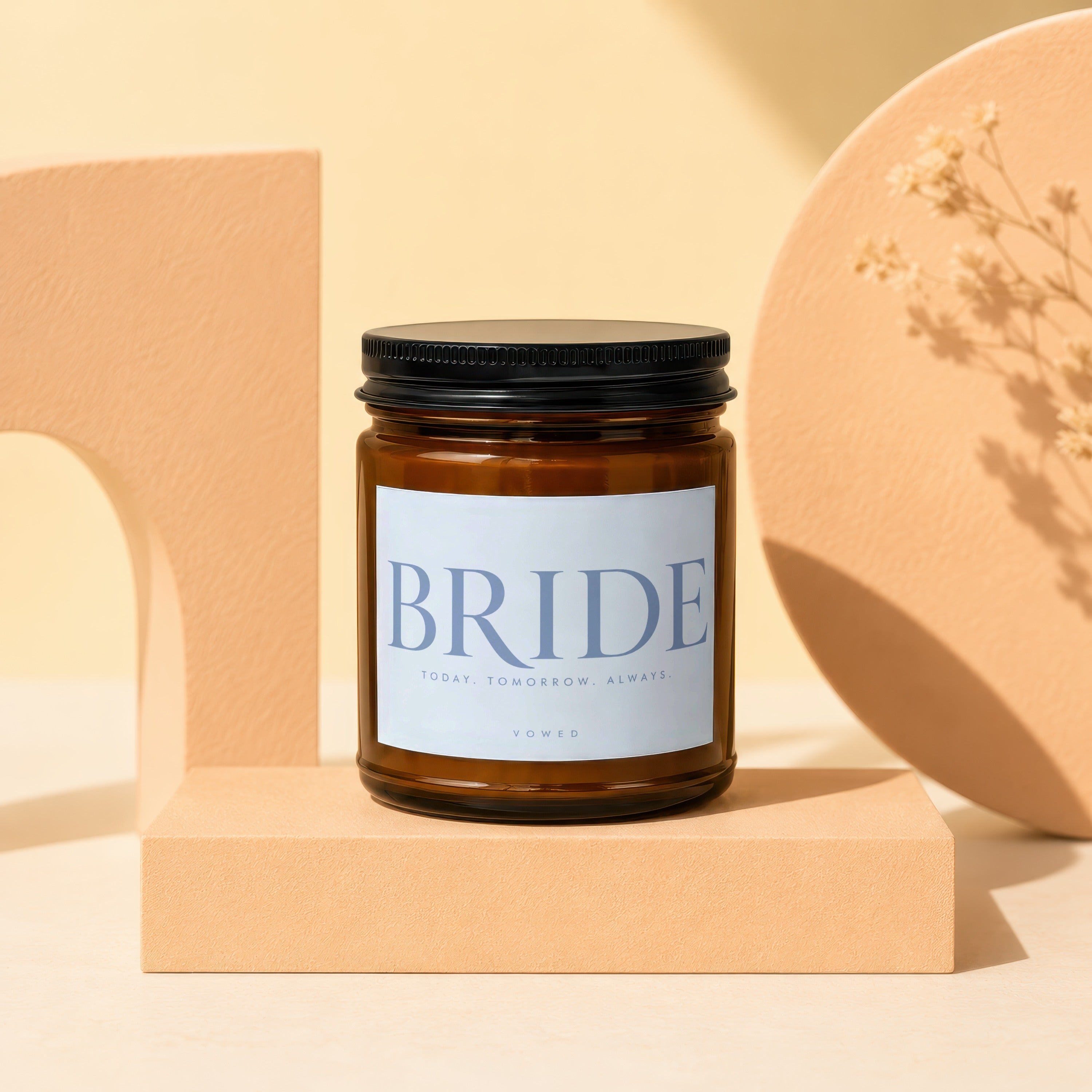 Amber jar candle with a white label that reads "BRIDE" and "VOWED".