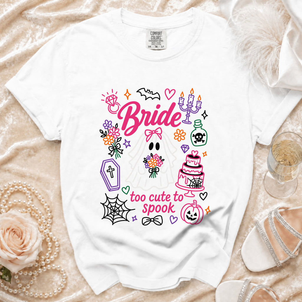 White t-shirt with "Bride" and Halloween graphics and text "too cute to spook".