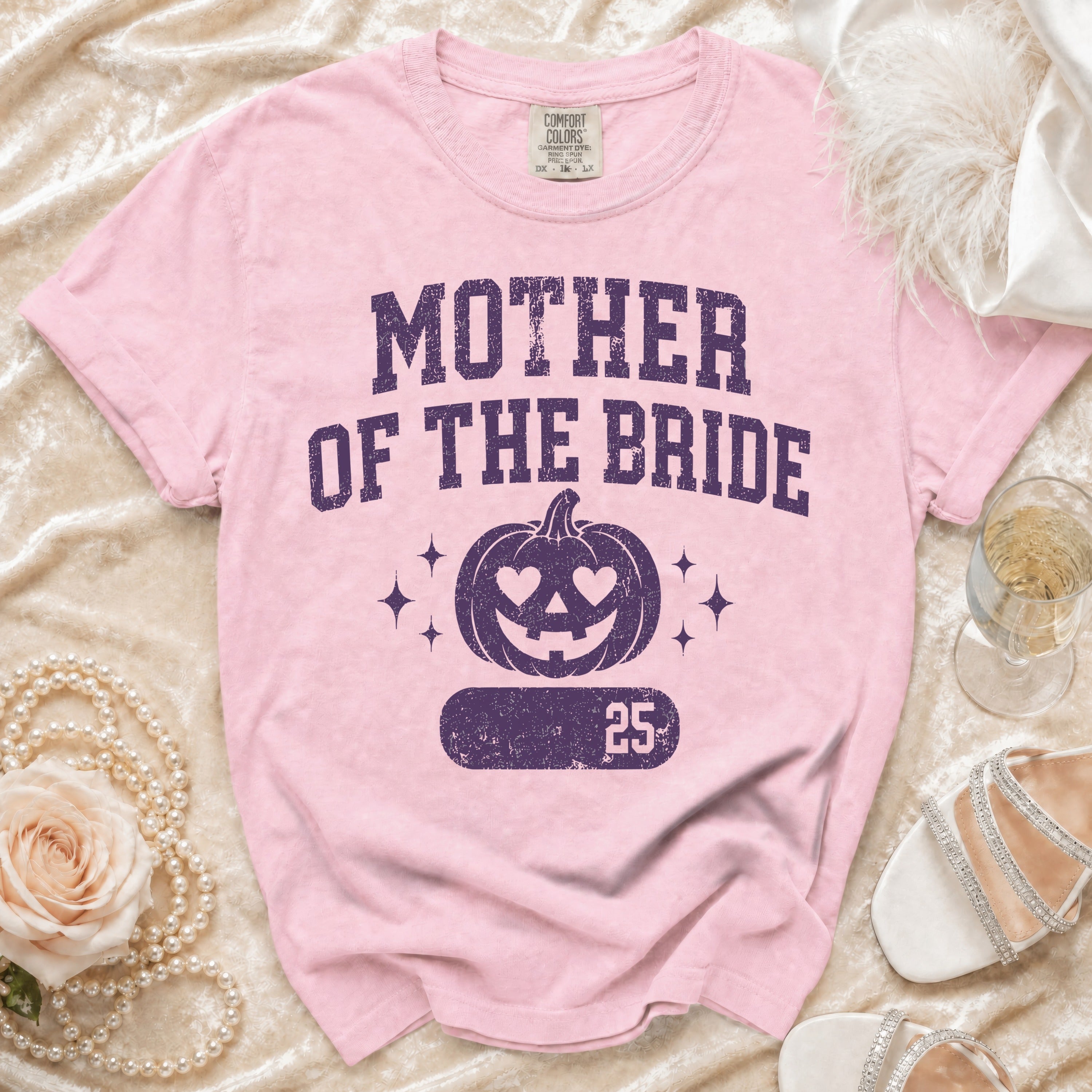 Pink t-shirt with "Mother of the Bride" text and a pumpkin graphic.