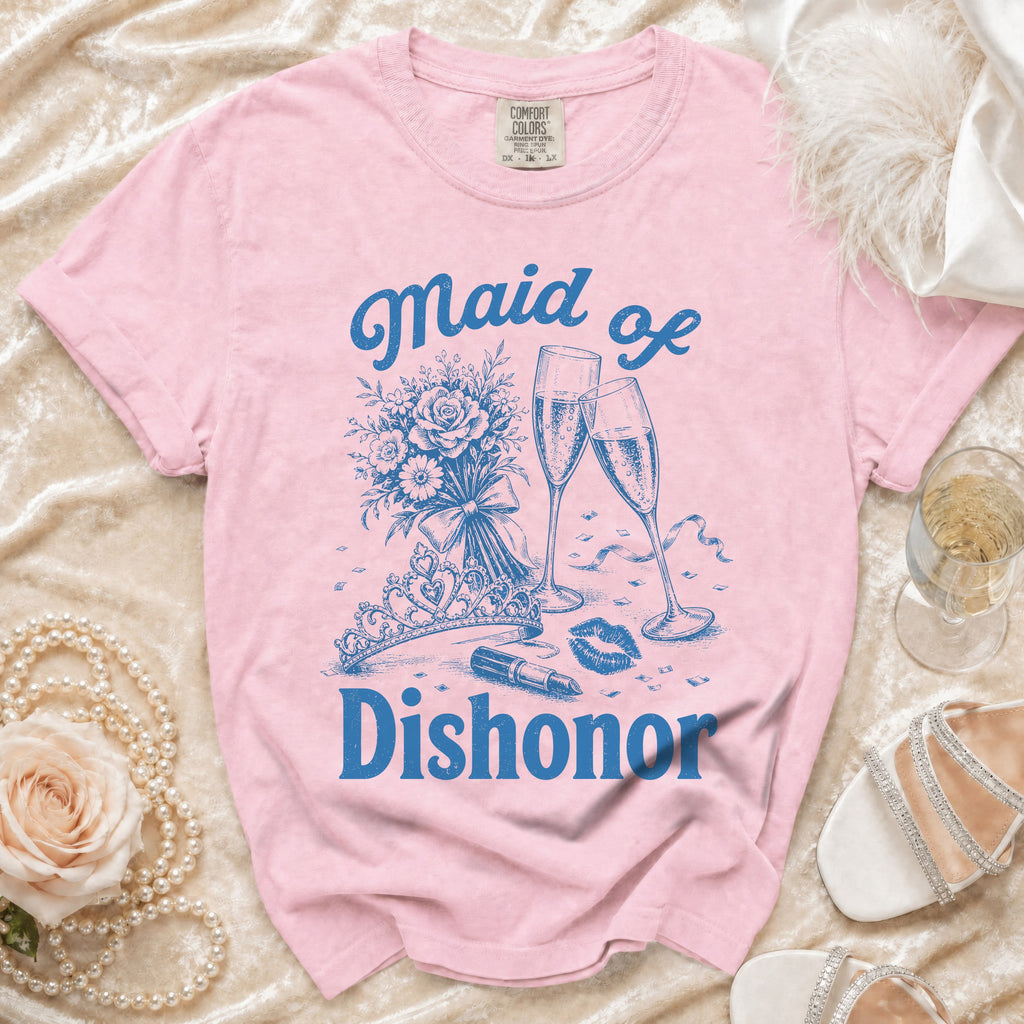 Pink t-shirt with blue text and graphics: "Maid of Dishonor," a bouquet, champagne, lipstick, and crown.
