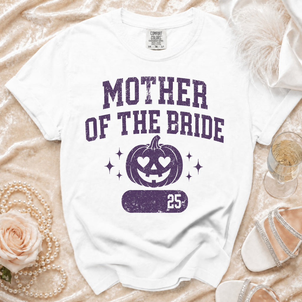 White t-shirt with "MOTHER OF THE BRIDE" and a jack-o'-lantern design.
