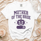 White t-shirt with "MOTHER OF THE BRIDE" and a jack-o'-lantern design.