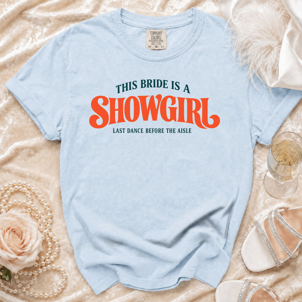 Light blue t-shirt with "This Bride Is A Showgirl" text.