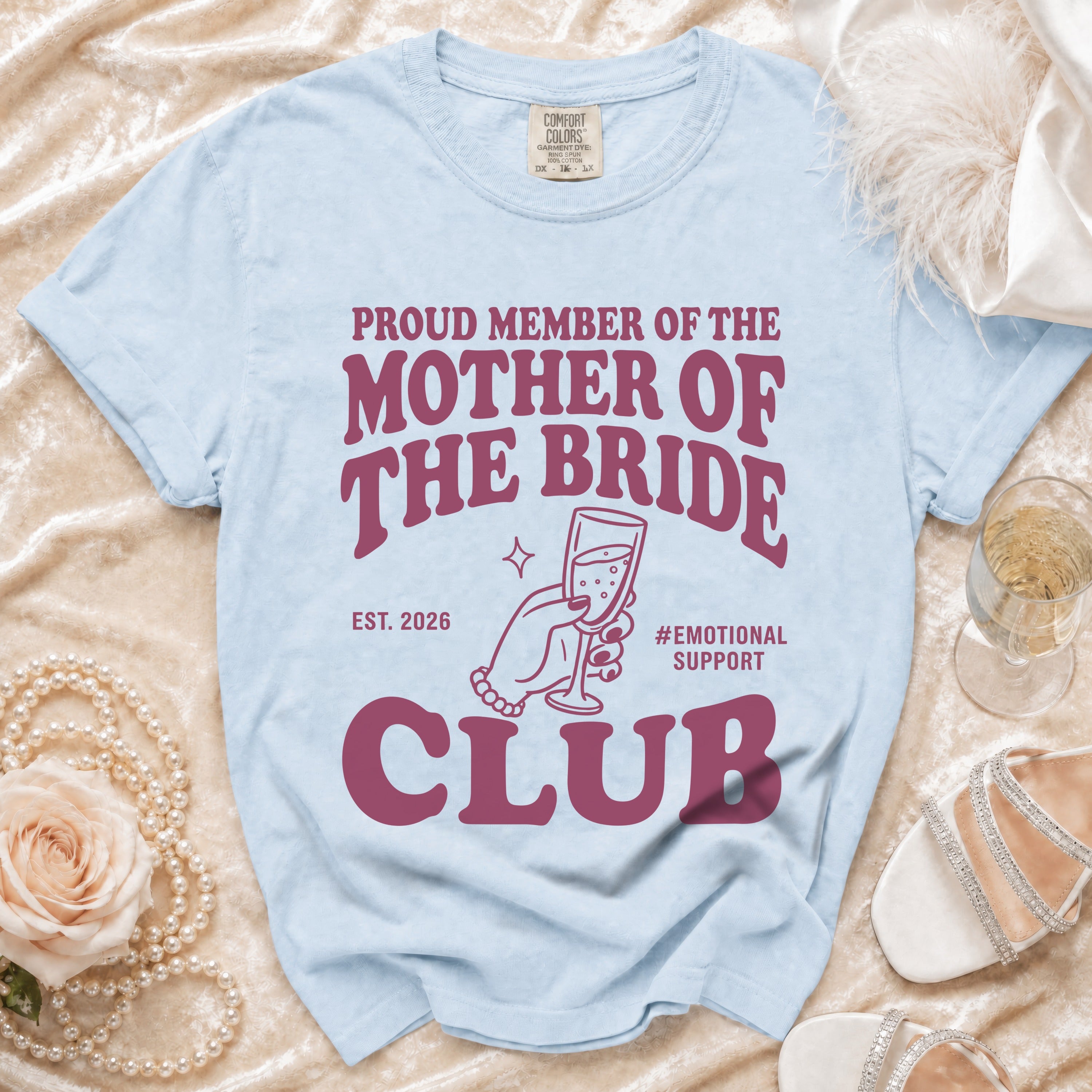 Light blue t-shirt with "Proud Member of the Mother of the Bride Club Est. 2026" text.