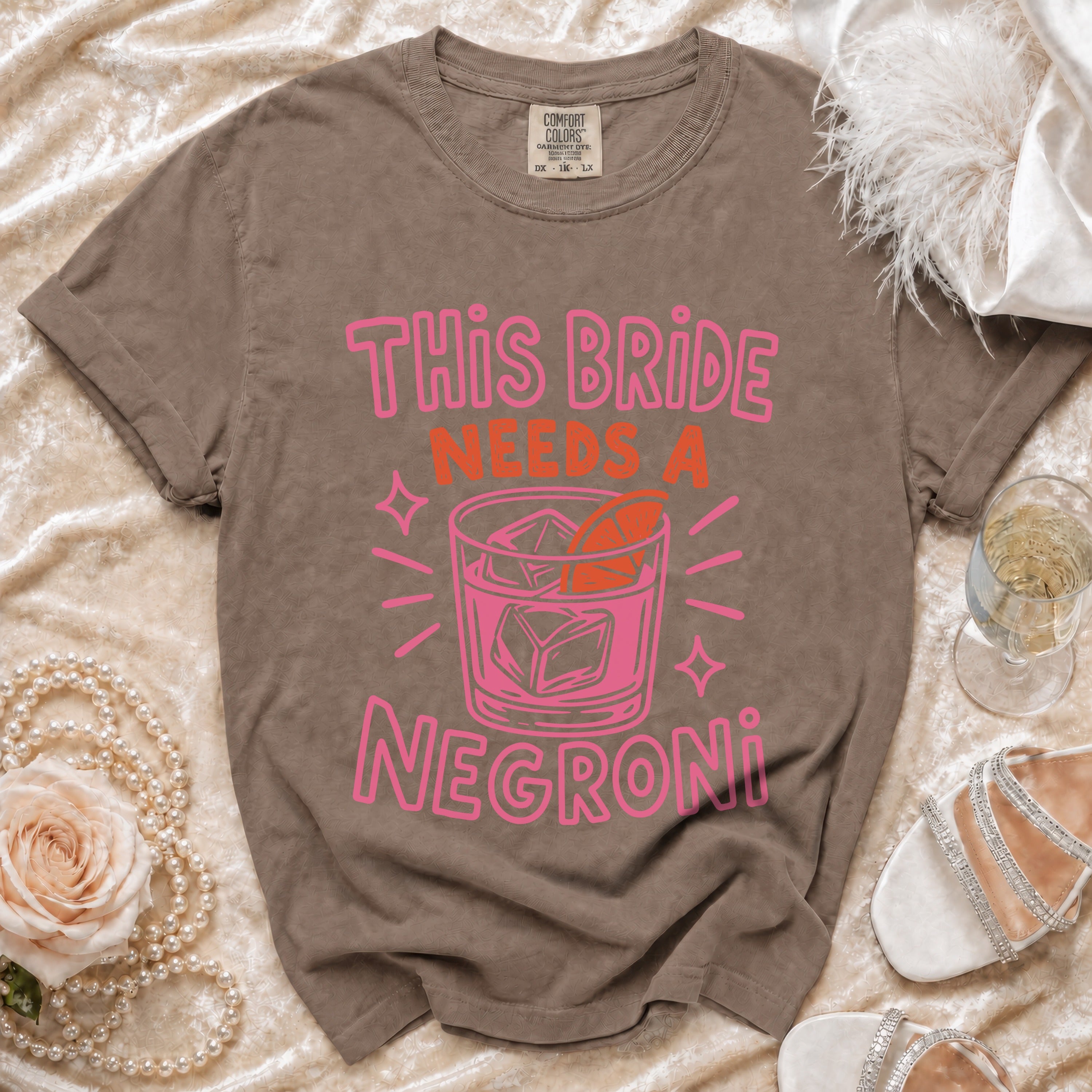 T-shirt with "This Bride Needs A Negroni" text and cocktail graphic.