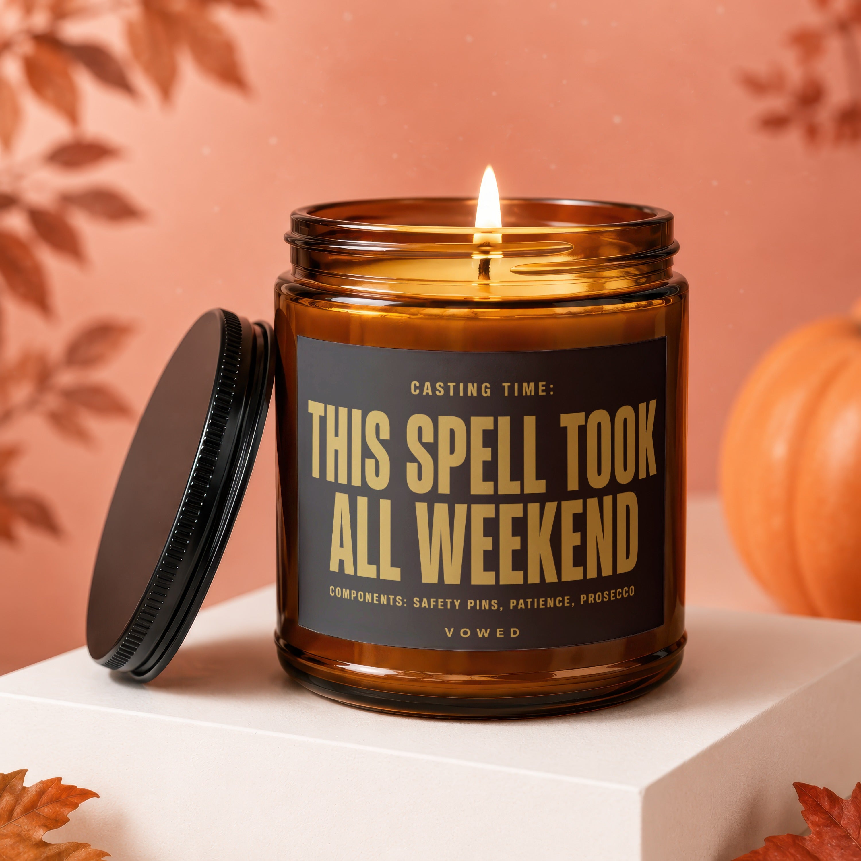 Amber candle with gold text "THIS SPELL TOOK ALL WEEKEND" and "VOWED".