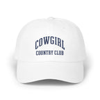 White baseball cap with embroidered navy blue text reading COWGIRL COUNTRY CLUB centered on the front.