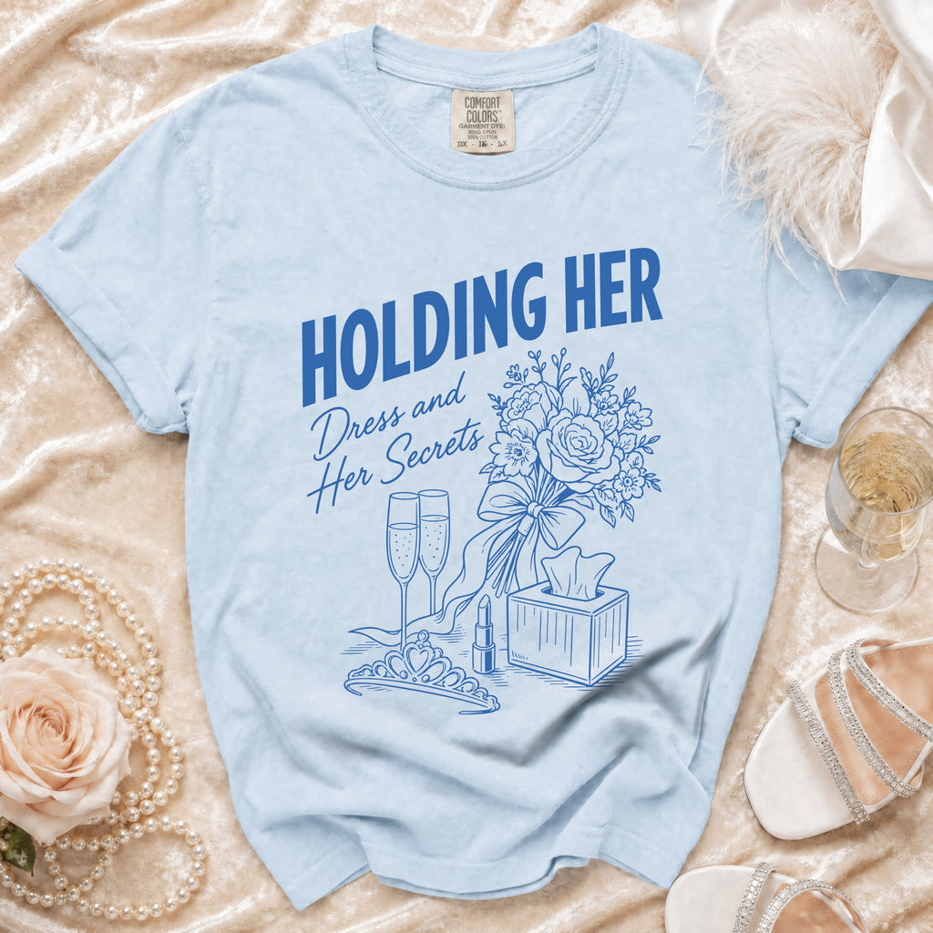 Light blue t-shirt with "HOLDING HER" and "Dress and Her Secrets" graphics.