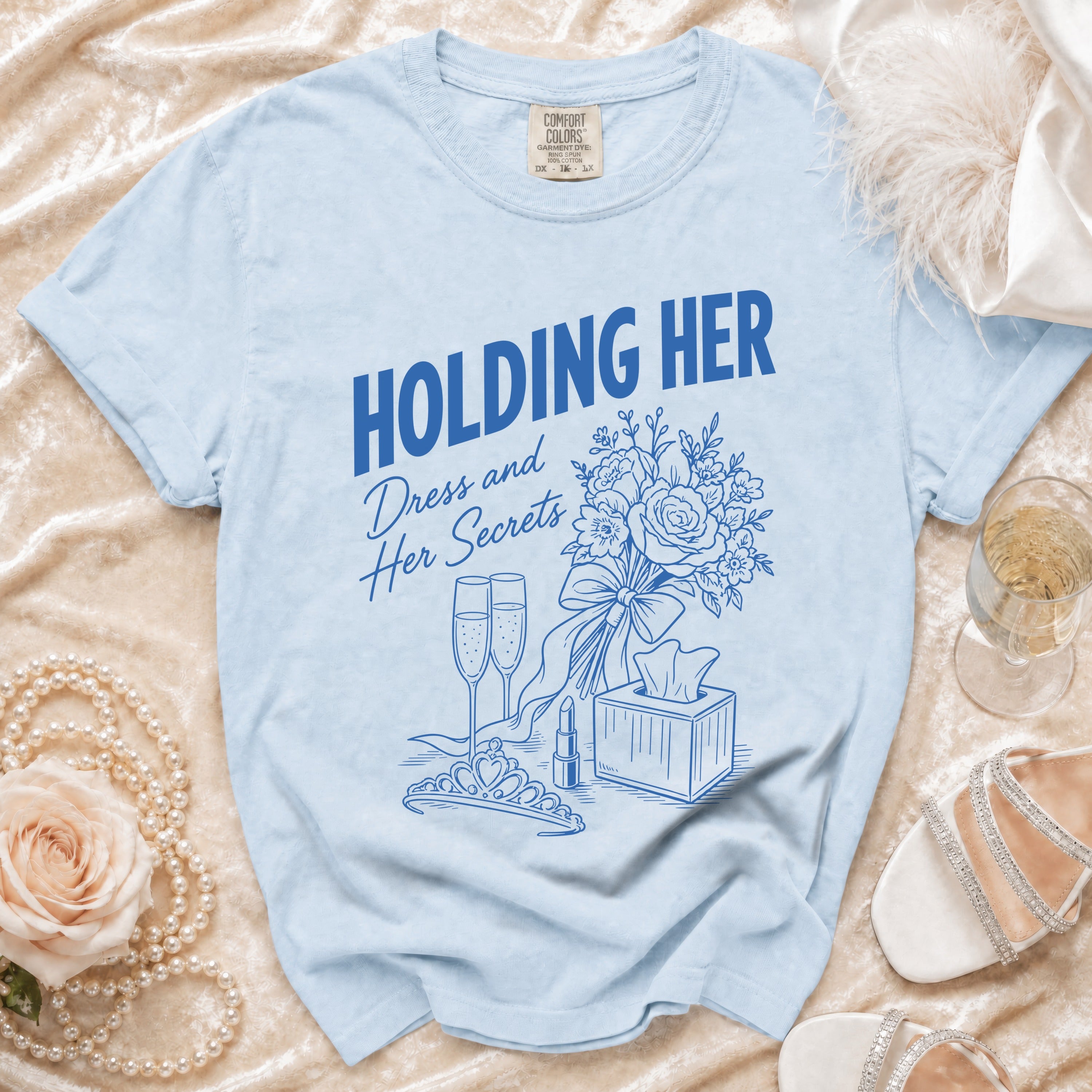 Light blue t-shirt with "HOLDING HER" and "Dress and Her Secrets" graphics.