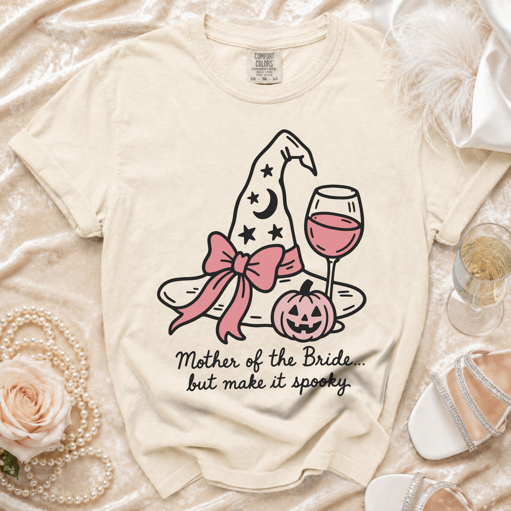 Cream t-shirt with witch hat, pumpkin, wine glass graphic and text.