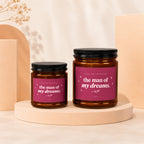 Two amber glass candles with pink labels that read "Thank You For Raising the man of my dreams."
